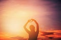 Women hands forming a heart with sunset silhouette Royalty Free Stock Photo