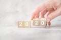 Women hands hold wooden cubes 2020. new goals for next year Royalty Free Stock Photo