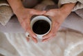 Women hands holding cup with hot black coffee Royalty Free Stock Photo