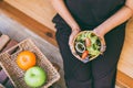 Woman hands holding and eating healthy salad for breakfast in the morning,Clean eating and dieting Royalty Free Stock Photo