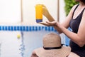 Woman hands holding sunscreen cream,Female using sunblock at swimming pool,Summer travel concept Royalty Free Stock Photo