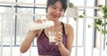 Women hands holding white glass of milk pouring from bottle. Asian women smile laugh look at camera health care home fitness Royalty Free Stock Photo