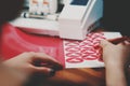 women hands with painted nails use tool to weed freshly cut pink peace dove stickers