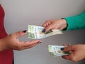 women hands paying and receiving mexican money Royalty Free Stock Photo