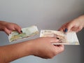 women hands paying and receiving Peruvian money