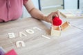 Women hands pick Heart shaped yarn out of gift box