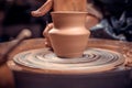 Women hands. Potter at work. Creating dishes. Potter's wheel. Dirty hands in the clay and the potter's wheel Royalty Free Stock Photo