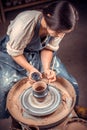 Master-ceramist creates a clay pot on a potter& x27;s wheel. Hands of potter close up. Ancient craft and pottery handmade Royalty Free Stock Photo