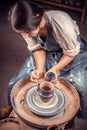 Master-ceramist creates a clay pot on a potter& x27;s wheel. Hands of potter close up. Ancient craft and pottery handmade Royalty Free Stock Photo