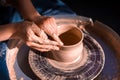 Women hands. Potter at work. Creating dishes. Potter& x27;s wheel. Dirty hands in the clay and the potter& x27;s wheel with the Royalty Free Stock Photo