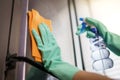 Women hands in rubber green gloves cleaning the Refrigerator at home kitchen,  for corona virus or Covid-19 protection Royalty Free Stock Photo