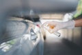 Woman hand spraying alcohol on car door handle,Preventive measures against coronavirus,Covid-19 pandemic Royalty Free Stock Photo