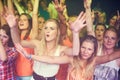 Women, hands up and dancing at music festival, live band performance and techno rave party in nightclub, concert and Royalty Free Stock Photo