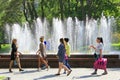 Women have a rest in city park with fountains