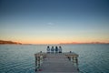 Women have rest on the pier in summer evening by the sea. Mallorca, Spain. summer vacation with friends Royalty Free Stock Photo