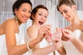 Women having fun while bridal dress fitting in shop Royalty Free Stock Photo