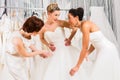 Women having fun during bridal dress fitting in shop Royalty Free Stock Photo