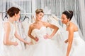 Women having fun during bridal dress fitting in shop Royalty Free Stock Photo