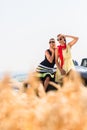 Women having joyride in convertible car having rest