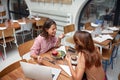 Two women having lunch at restaurant while doing business. friends, lesbian, conversation