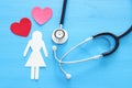 women healf Insurance . concept image of Stethoscope and female figure on wooden table. top view. Royalty Free Stock Photo