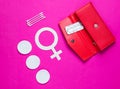 Women Health. Products for feminine hygiene, self-care, female gender symbol on pink background. Ear sticks, pads, pills in purse