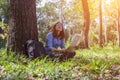 Women hiker with backpack checks map to find directions in wilderness area Royalty Free Stock Photo