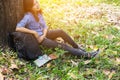 Women hiker with backpack checks map to find directions in wilderness area Royalty Free Stock Photo