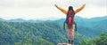 Women hiker or traveler with backpack adventure feeling victorious facing on the mountain, outdoor for education nature on vacatio Royalty Free Stock Photo