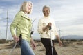 Women Hiking Near Wind Farm