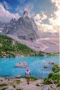 women hiking to the Lago di Sorapis lake in Italian Dolomites, blue lake Lago di Sorapis Italy.