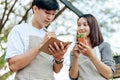 Women hold cactus and a man writing note in a book. Love couple enjoy hobby with garden cactus Royalty Free Stock Photo