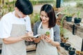 Women hold cactus and a man writing note in a book. Love couple enjoy hobby with darden cactus Royalty Free Stock Photo