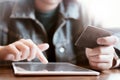 Women hold card and use tablet on wood table,Online shopping,hands holding credit card and using laptop Royalty Free Stock Photo