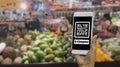 Women hold smartphones in hand,scanning store QR code to check prices,receive promotions and discount in supermarket