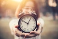 Women hold vintage clock in her hand for showing times