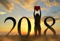 Women holding balloon in heart shape in hands while celebrating New Year 2018 Royalty Free Stock Photo