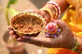 Indian Bride holding Turmeric paste or haldi paste in hand in a Hindu wedding ceremony. Royalty Free Stock Photo