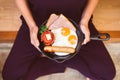 Woman holding and eating meal served with sausage,ham,fried egg at home,Healthy breakfast in the morning,Enjoys of resting time,To Royalty Free Stock Photo