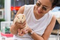 Women holding guinea pig at outdorrs garden.