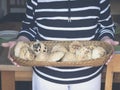 Women holding home baked buns and bread in bread basket Royalty Free Stock Photo