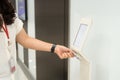 Women holding key card access control to unlock elevator floor and choose the floor