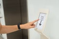 Women holding key card access control to unlock elevator floor and choose the floor Royalty Free Stock Photo