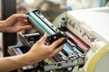 Women holding Laser toner cartridge ,replacing toner in laser printer at office. Repairs and Maintenance printers concept , Royalty Free Stock Photo