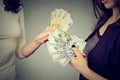 Women holding money exchanging with each other dollars to euro cash Royalty Free Stock Photo