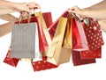 Women holding paper shopping bags on white, closeup Royalty Free Stock Photo