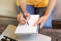 Women holding a pen writing a notebook. Recording and business concept.