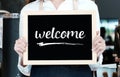 Women holding welcome sign board at cafe background, small business owner, food and drink industry concept Royalty Free Stock Photo