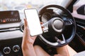 Women holds a smartphone with mockup in the car