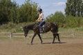 Women is horse riding - red hair girl in summer meadow Royalty Free Stock Photo